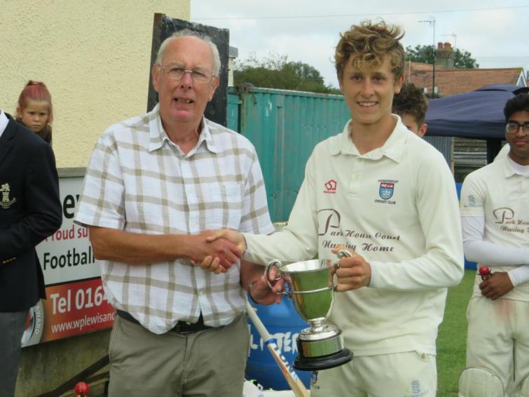 Tony Scourfield hands over the trophy to skipper Tom Mansbridge